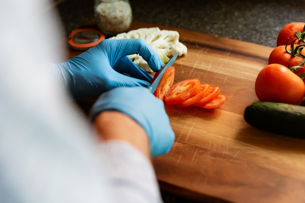 Food preparation wearing First Glove blue nitrile exam gloves